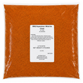 Bag of orange powder with a label on a white background